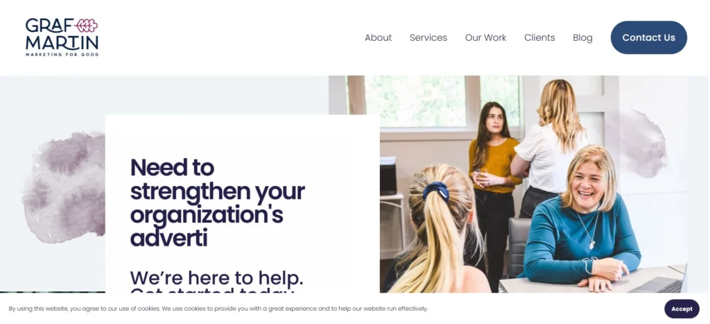 “Graf-Martin Communications homepage showing a smiling team in a meeting room with overlay text offering help to strengthen organizational advertising.”