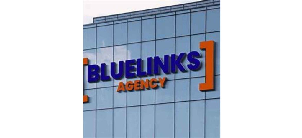 Bluelinks Agency logo on a glass building wall, showcasing a vibrant orange and blue design representing a fast-growing digital firm.
