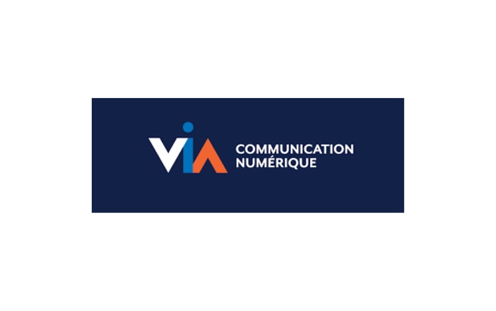 Logo of VIA Communication Numérique featuring a stylized "VIA" with blue and orange accents, next to the agency name in white text on a dark blue background, representing digital marketing and advertising in Québec City.