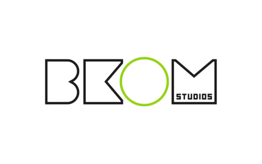 Bkom Studios logo with stylized black lettering and a lime green circle forming the 'O', designed in a modern, playful style."