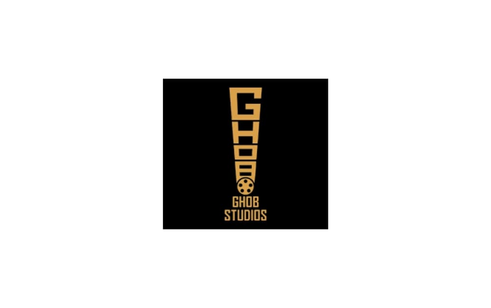 Logo of GHOB Studios featuring a bold vertical yellow exclamation mark with film reel, on a black background.
