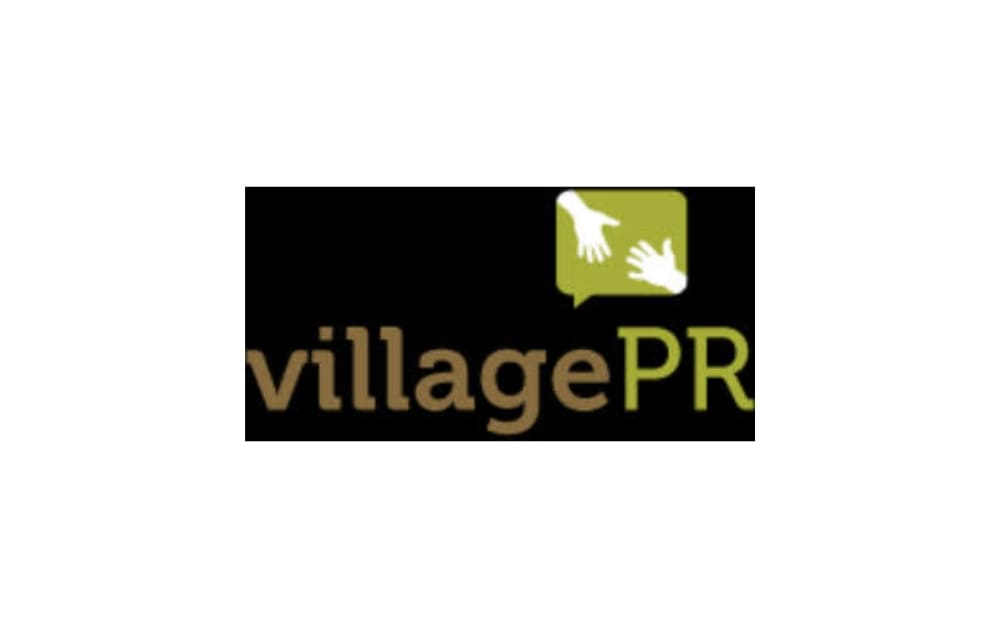 Village PR logo with brown and green text, featuring two white hands reaching inside a green speech bubble.