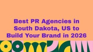 Promotional banner with purple headline text reading ‘Best PR Agencies in South Dakota, US to Build Your Brand in 2026’ on a peach background, with colorful abstract geometric patterns along the bottom.